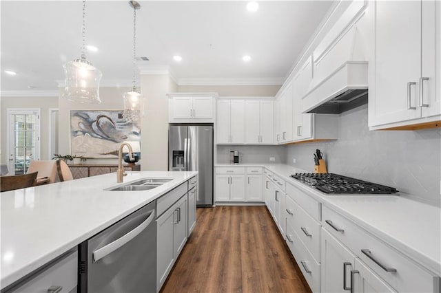 kitchen with crown molding, light countertops, a sink, stainless steel appliances, and decorative backsplash
