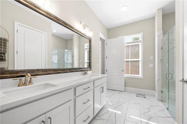full bath featuring marble finish floor, a sink, and a stall shower