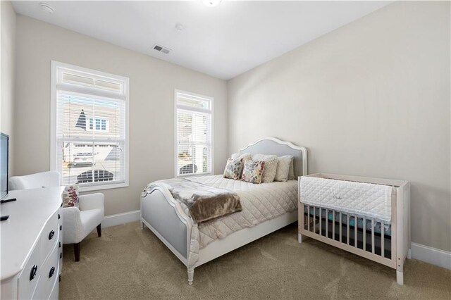bedroom with baseboards, carpet flooring, and visible vents