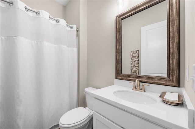 full bathroom with toilet and vanity
