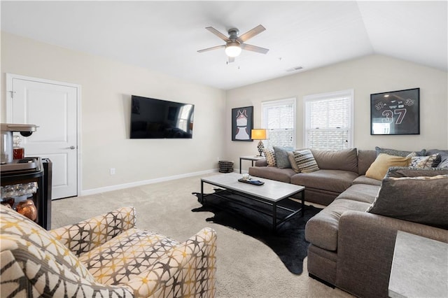 carpeted living area featuring baseboards, lofted ceiling, visible vents, and a ceiling fan