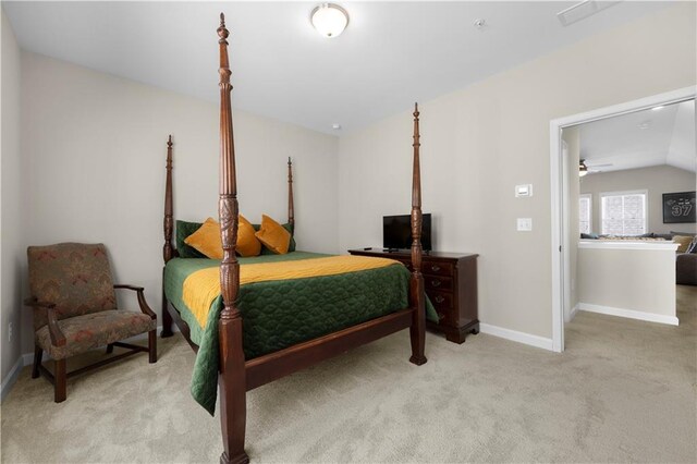 bedroom featuring baseboards, carpet floors, and lofted ceiling