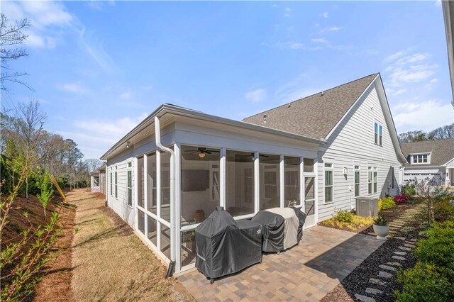 back of house featuring a sunroom and a patio