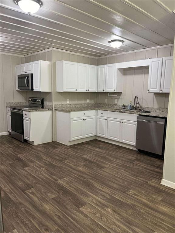 kitchen featuring sink, white cabinetry, stainless steel appliances, and dark hardwood / wood-style floors