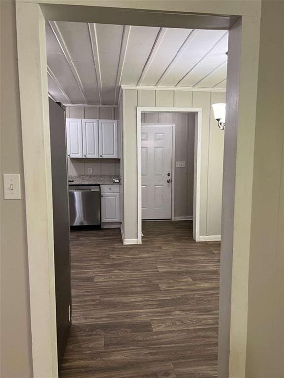 interior space featuring dark wood-type flooring and baseboards