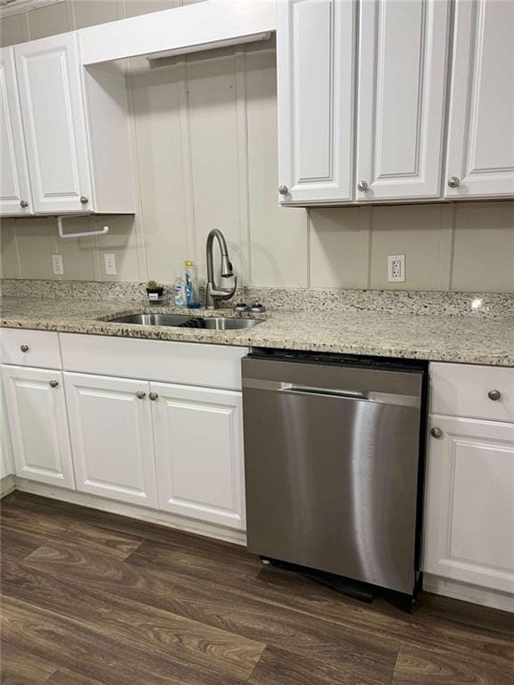 kitchen with dark wood-type flooring, white cabinetry, dishwasher, and a sink