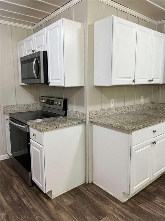 kitchen with white cabinets, dark wood-style floors, light stone counters, and stainless steel appliances