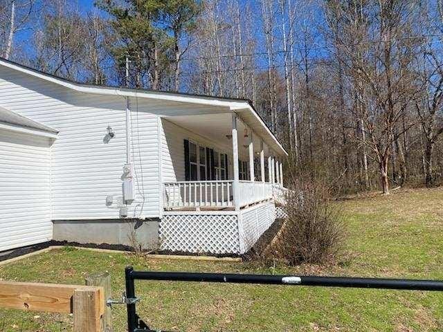 view of home's exterior featuring covered porch and a lawn