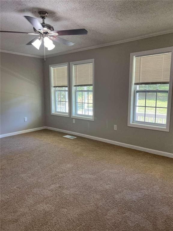 carpeted spare room with crown molding, a textured ceiling, and ceiling fan