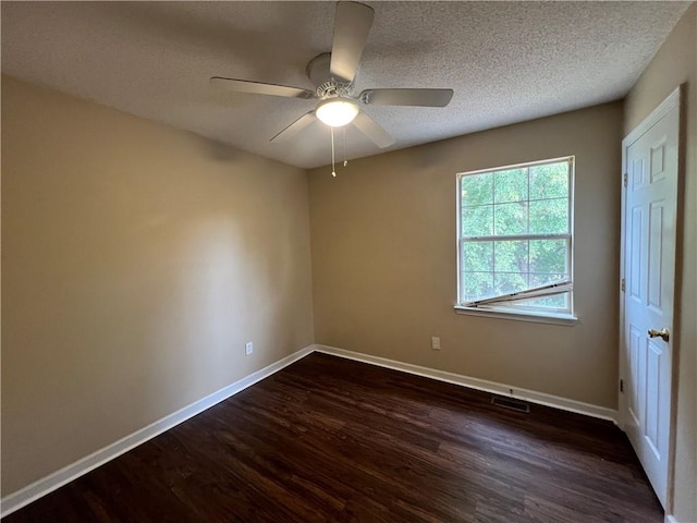 empty room with dark wood-type flooring, ceiling fan, and a textured ceiling