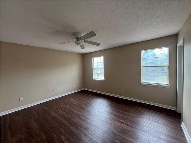 unfurnished room featuring a textured ceiling, dark wood-type flooring, and ceiling fan