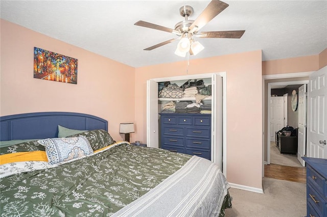 bedroom featuring carpet, a closet, a ceiling fan, and baseboards
