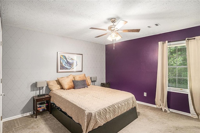 carpeted bedroom with baseboards, a textured ceiling, and ceiling fan