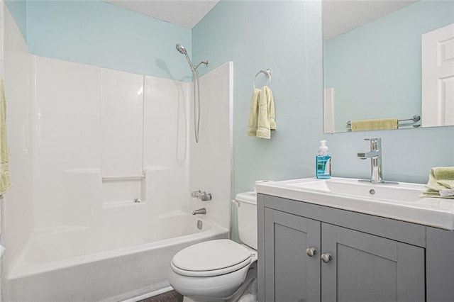 bathroom featuring toilet, a textured ceiling, bathtub / shower combination, and vanity