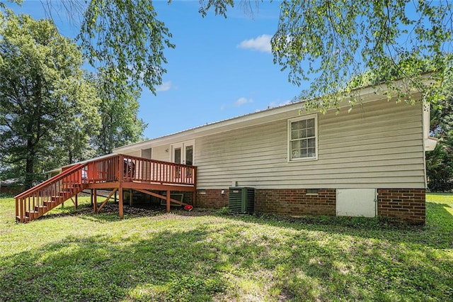 back of house featuring crawl space, a lawn, stairs, and a wooden deck