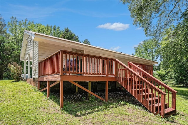 wooden deck with a lawn and stairway