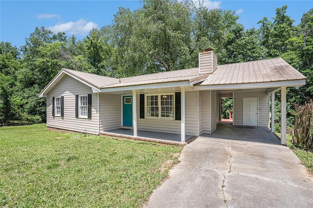 single story home with a front yard, a porch, driveway, an attached carport, and metal roof
