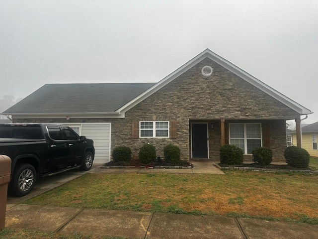 single story home featuring a garage and a front yard