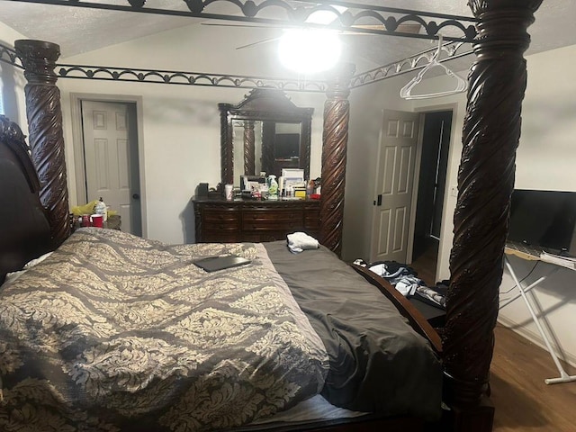 bedroom featuring wood-type flooring, lofted ceiling, and ceiling fan