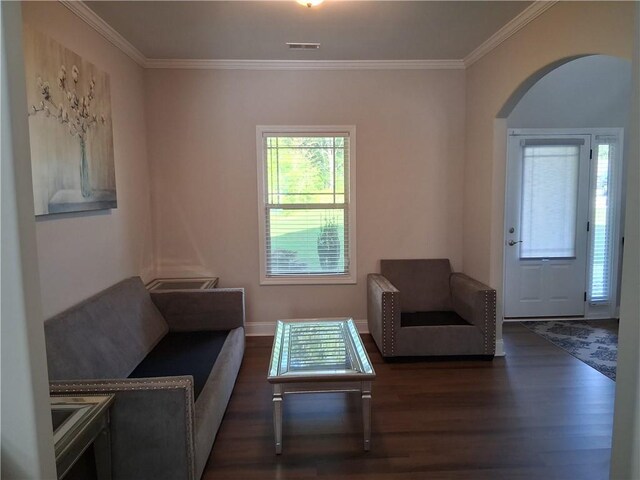 2647 Old Snapping Shoals Rd, Mcdonough, GA 30252 - living area with dark wood finished floors, arched walkways, crown molding, and baseboards