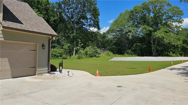 2647 Old Snapping Shoals Rd, Mcdonough, GA 30252 - garage featuring driveway and view of scattered trees