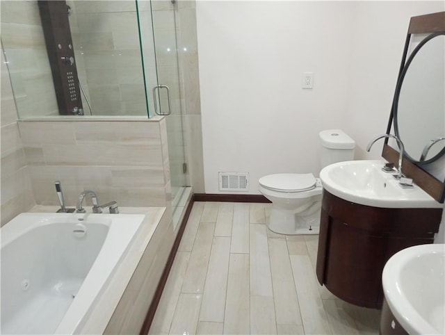 full bathroom with toilet, wood finish floors, visible vents, a bath, and a stall shower