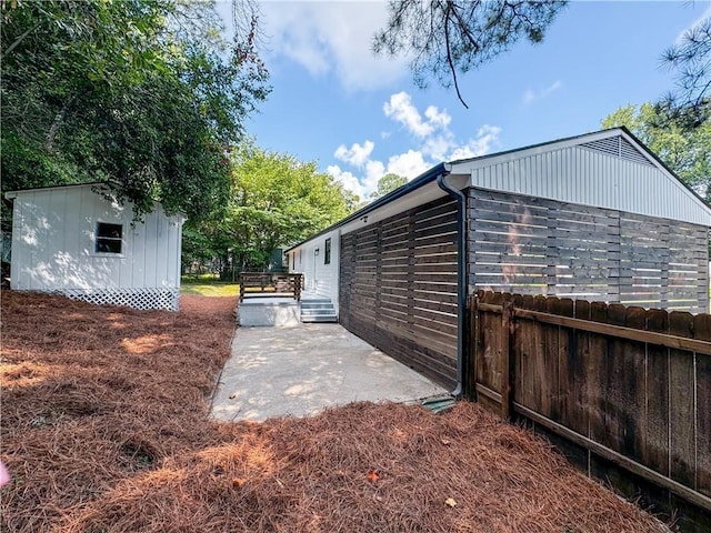 view of side of home with a patio area