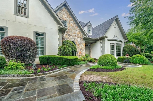 5318 Brooke Farm Dr, Dunwoody, GA 30338 - view of home's exterior featuring stone siding, stucco siding, and a lawn