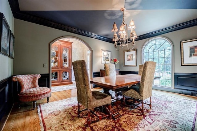 5318 Brooke Farm Dr, Dunwoody, GA 30338 - dining room featuring ornamental molding, a chandelier, wood finished floors, arched walkways, and wainscoting