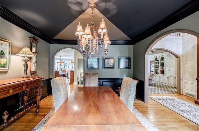 5318 Brooke Farm Dr, Dunwoody, GA 30338 - dining room with a chandelier, crown molding, arched walkways, wood finished floors, and vaulted ceiling