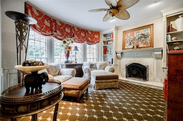 5318 Brooke Farm Dr, Dunwoody, GA 30338 - sitting room featuring built in features, ceiling fan, a high end fireplace, and crown molding
