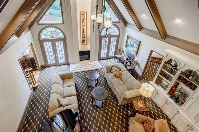 5318 Brooke Farm Dr, Dunwoody, GA 30338 - living room with french doors, plenty of natural light, a high ceiling, baseboards, and beamed ceiling