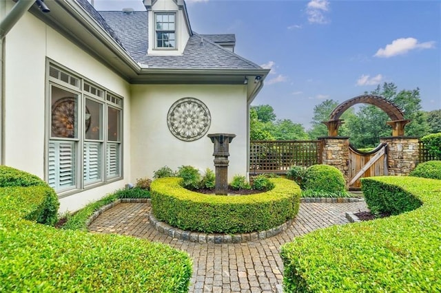 5318 Brooke Farm Dr, Dunwoody, GA 30338 - view of side of home with stucco siding and roof with shingles