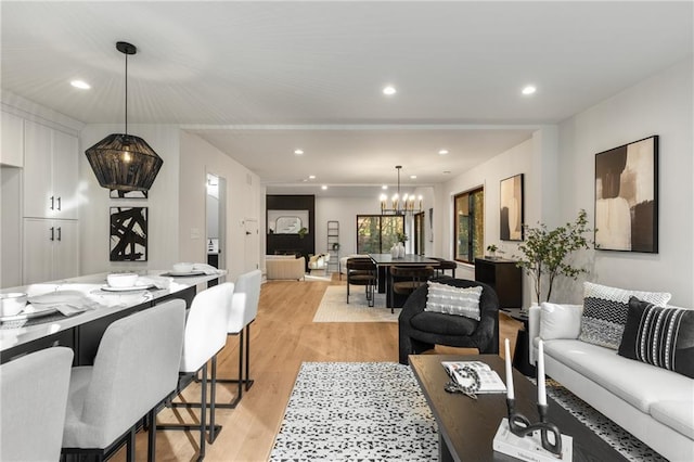 living room featuring light hardwood / wood-style flooring and a notable chandelier