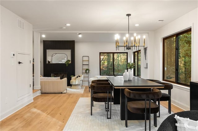 dining room with a chandelier and light hardwood / wood-style floors