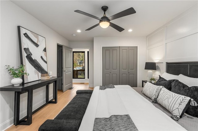 bedroom with ceiling fan, a closet, and light hardwood / wood-style flooring