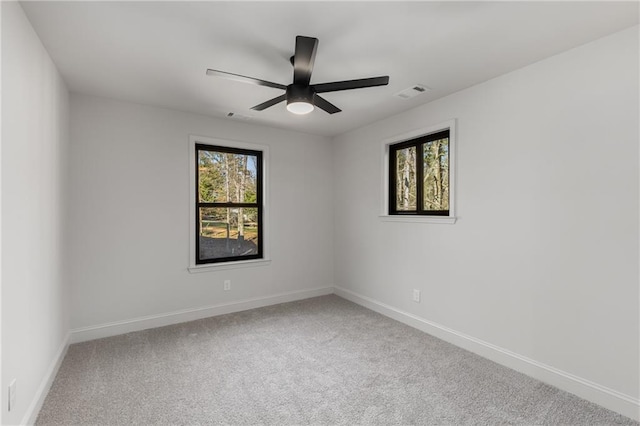 carpeted empty room featuring ceiling fan