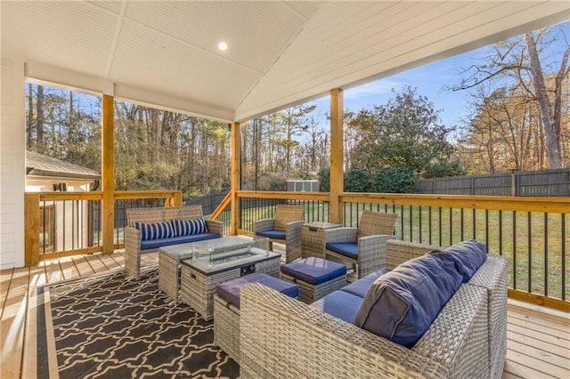 sunroom / solarium featuring a healthy amount of sunlight and lofted ceiling