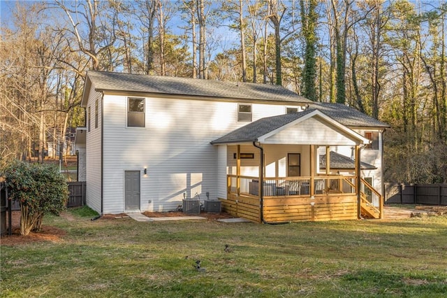 view of front of property with a deck, a front yard, and central air condition unit