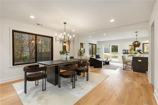 dining area with a chandelier and light wood-type flooring