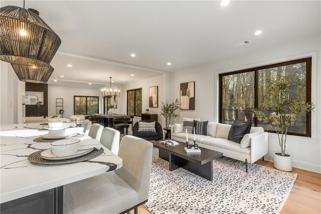 living room featuring a notable chandelier and light hardwood / wood-style floors