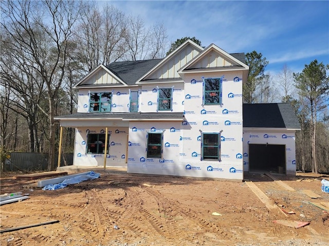 unfinished property featuring a garage and covered porch