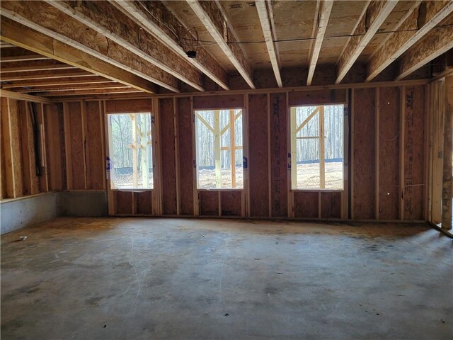 empty room featuring lofted ceiling, carpet flooring, and ceiling fan