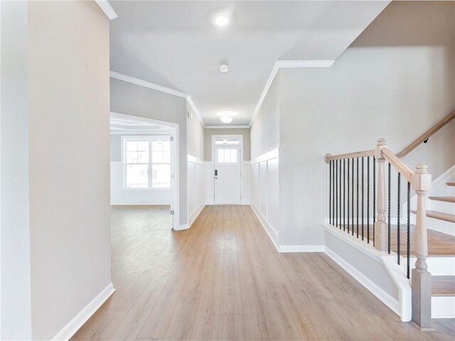 unfurnished room with a raised ceiling, ornamental molding, and light hardwood / wood-style floors