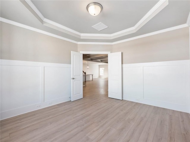 hall with light hardwood / wood-style flooring and ornamental molding