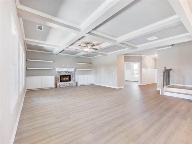 empty room with a healthy amount of sunlight, a chandelier, and light hardwood / wood-style flooring