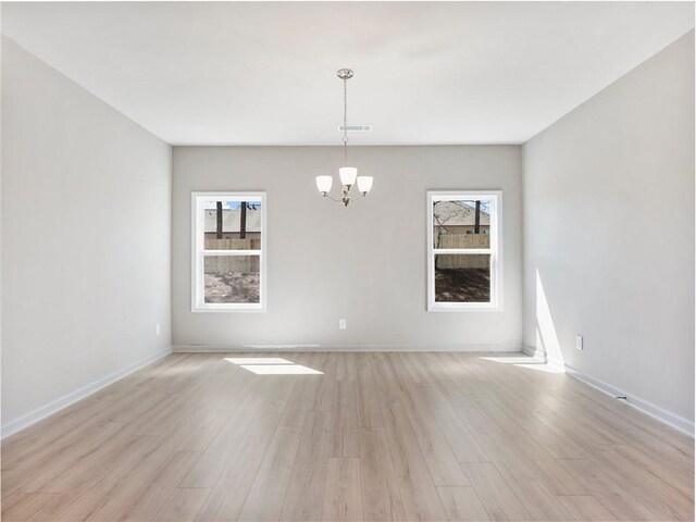 kitchen with pendant lighting, sink, dishwasher, white cabinetry, and a center island with sink