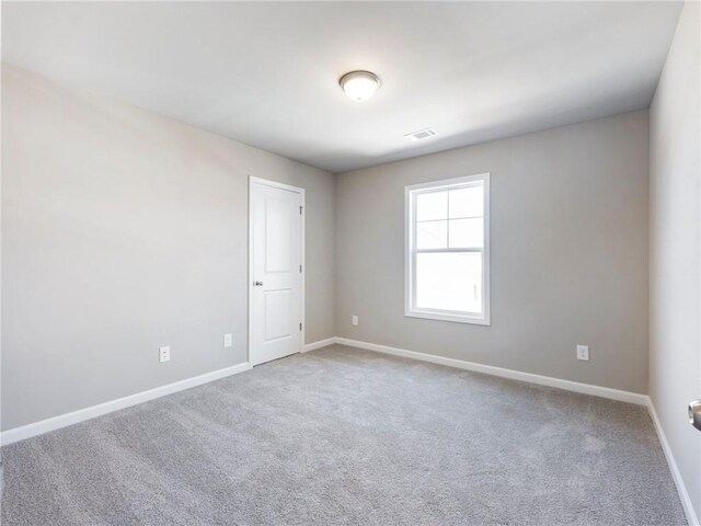 unfurnished bedroom featuring a closet and light carpet