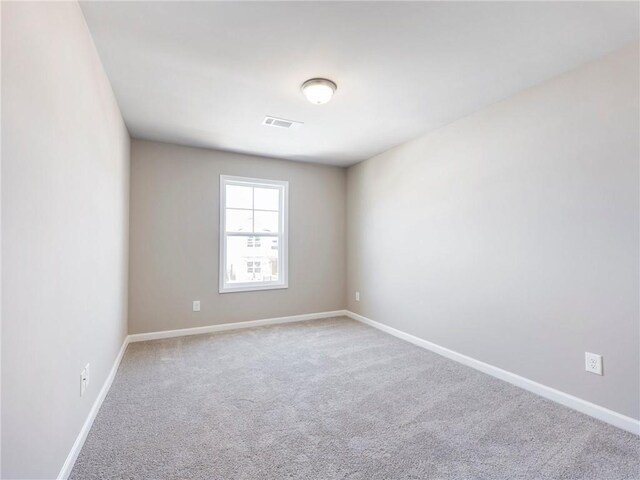 unfurnished bedroom featuring light colored carpet, a spacious closet, and a closet