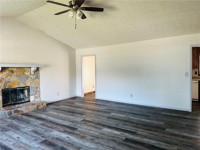 unfurnished living room with dark wood-type flooring, lofted ceiling, a fireplace, a textured ceiling, and a ceiling fan